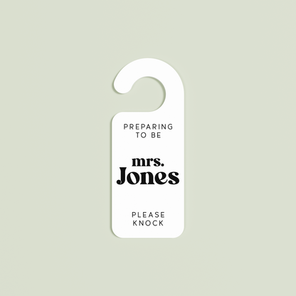 White Alba door hanger with 'Preparing to be mrs. Jones please knock' black text | Saint Sauvant Auckland NZ