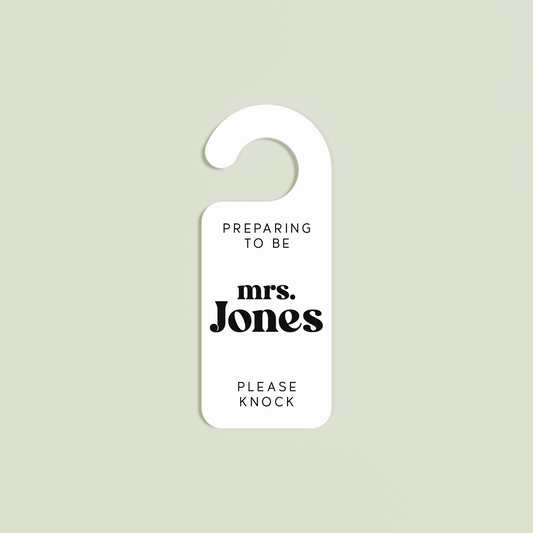 White Alba door hanger with 'Preparing to be mrs. Jones please knock' black text | Saint Sauvant Auckland NZ
