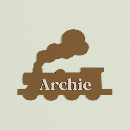 Double Layered chocolate train-shaped name plaque with 'Archie' in Oat | Saint Sauvant Auckland NZ