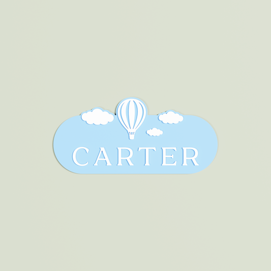 Personalized name plaque with 'Carter' in white and a hot air balloon design on a light blue background | Saint Sauvant Auckland NZ