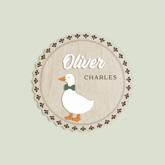 Wooden circle name plaque with a floral edge with a goose and 'Oliver Charles' | Saint Sauvant Auckland NZ 