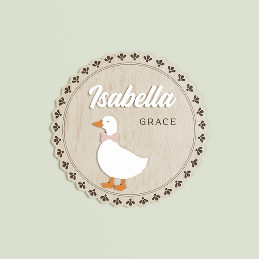 Wooden circle name plaque with a floral edge with a goose and 'Isabella Grace' | Saint Sauvant Auckland NZ 