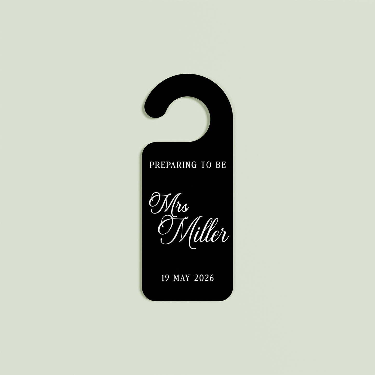 Black Promesse door hanger with 'Preparing to be Mrs Miller 19 May 2026' white text | Saint Sauvant Auckland NZ
