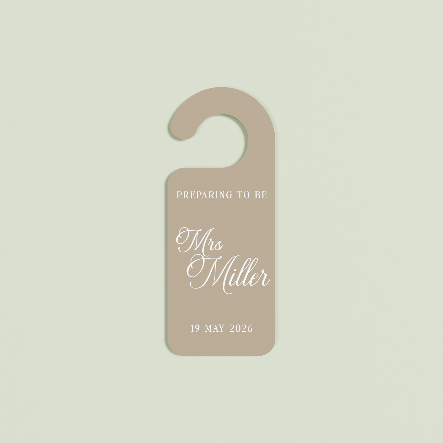 Light brown Promesse door hanger with 'Preparing to be Mrs Miller 19 May 2026' white text | Saint Sauvant Auckland NZ
