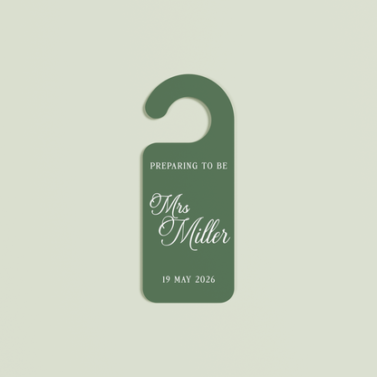 Sage Promesse door hanger with 'Preparing to be Mrs Miller 19 May 2026' white text | Saint Sauvant Auckland NZ