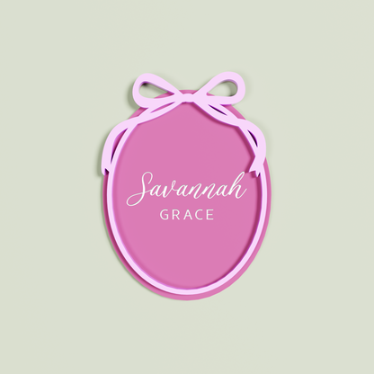 Double Layered Bubble Gum acrylic Oval engraved with 'Savannah Grace' with a Light Pink acrylic border and bow layer | Saint Sauvant Auckland NZ
