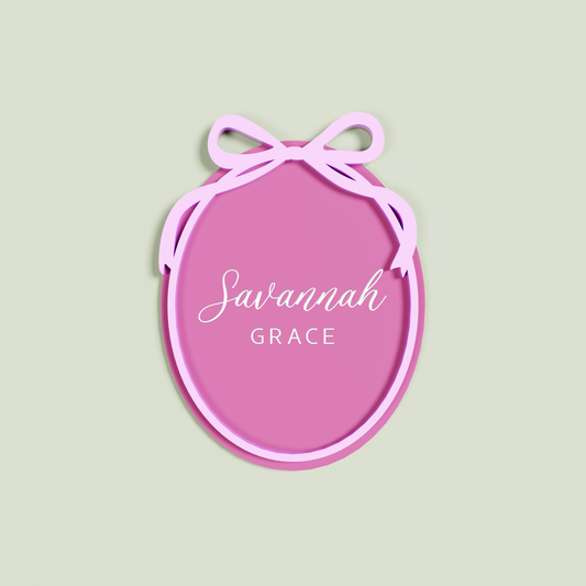 Double Layered Bubble Gum acrylic Oval engraved with 'Savannah Grace' with a Light Pink acrylic border and bow layer | Saint Sauvant Auckland NZ