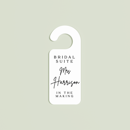 White Velo door hanger with 'Bridal Suite Mrs Harrison In The Making' black text | Saint Sauvant Auckland NZ