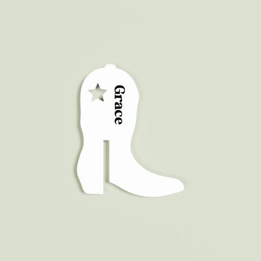 White cowboy boot-shaped drink tag with 'Grace' and a star on a light gray background
