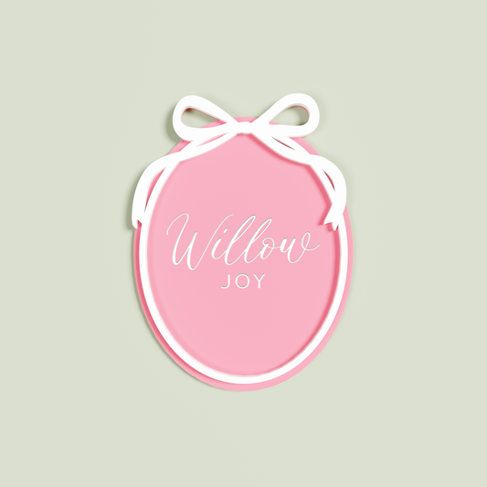 Double Layered Strawberry acrylic Oval engraved with 'Willow Joy' with a white acrylic border and bow layer | Saint Sauvant Auckland NZ